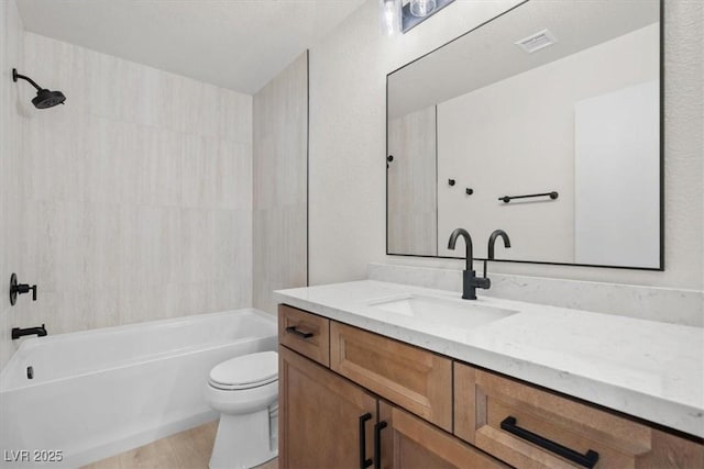 bathroom featuring vanity, toilet, visible vents, and shower / bath combination