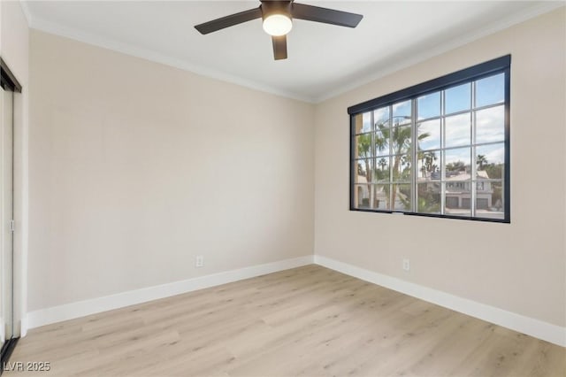 unfurnished room with baseboards, ornamental molding, and light wood finished floors