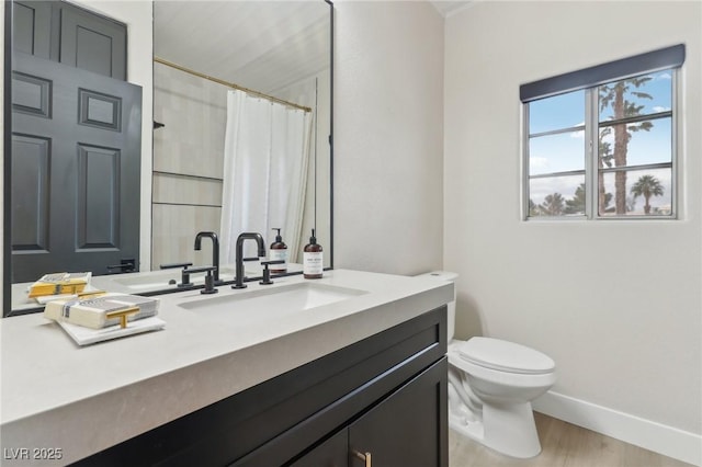 bathroom featuring toilet, wood finished floors, a shower with shower curtain, baseboards, and vanity