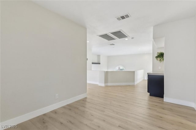 unfurnished room with visible vents, baseboards, and light wood finished floors