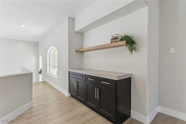 bar featuring recessed lighting, baseboards, and light wood-type flooring