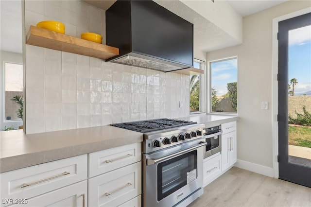 kitchen with backsplash, custom exhaust hood, white cabinets, stainless steel appliances, and open shelves