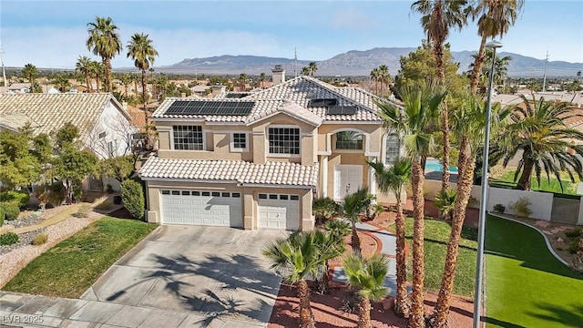 mediterranean / spanish-style house featuring stucco siding, a mountain view, and a tile roof