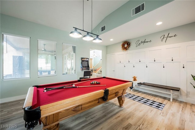 rec room featuring visible vents, wood finished floors, baseboards, and vaulted ceiling