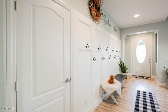 mudroom with recessed lighting, baseboards, and light wood finished floors