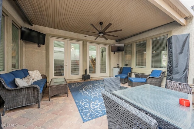 view of patio featuring a ceiling fan, an outdoor living space, and french doors