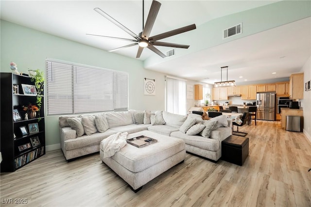 living room with light wood-type flooring, visible vents, recessed lighting, and a ceiling fan