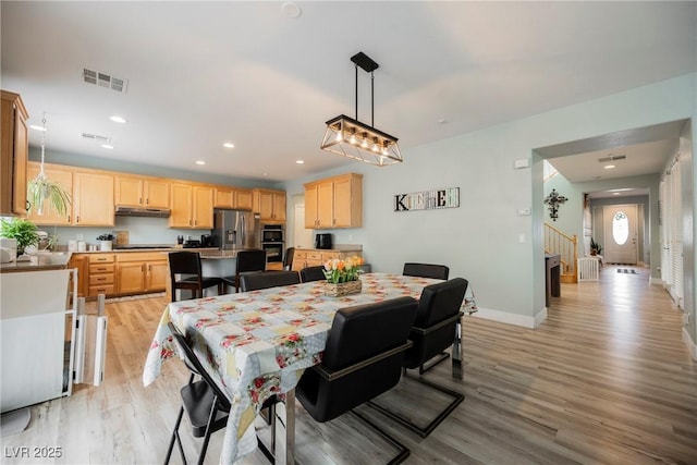 dining room with recessed lighting, light wood-style floors, visible vents, and baseboards