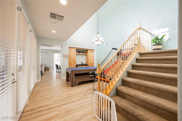 interior space featuring light wood-type flooring, visible vents, recessed lighting, and stairs