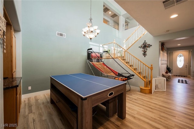 recreation room with visible vents, baseboards, and light wood finished floors