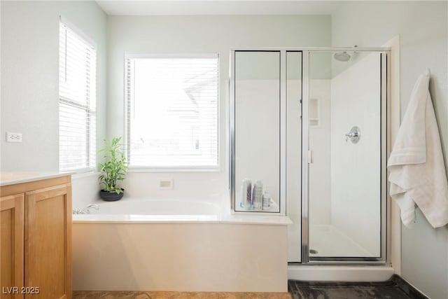 full bath with vanity, a bath, and a stall shower