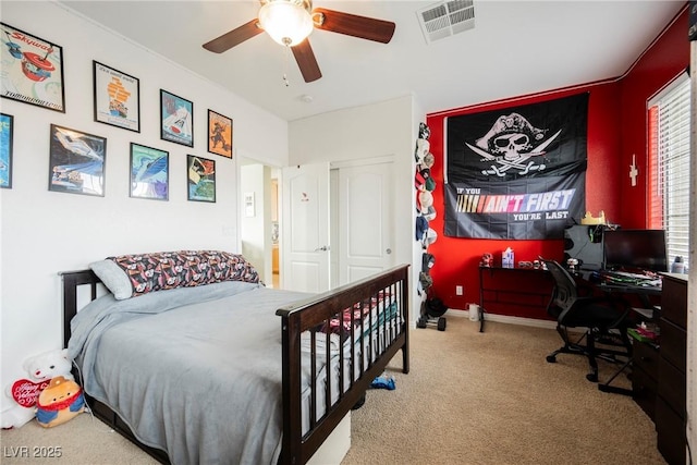 carpeted bedroom with a ceiling fan, visible vents, and baseboards