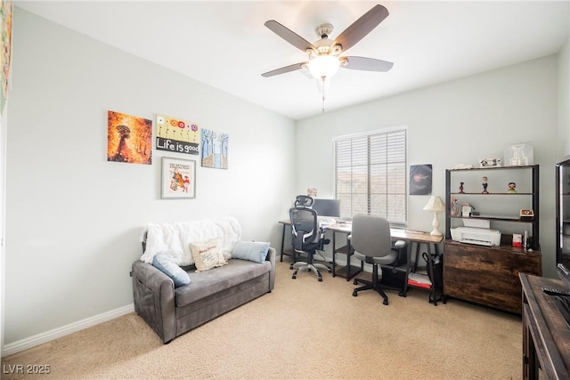 office space featuring carpet flooring, a ceiling fan, and baseboards