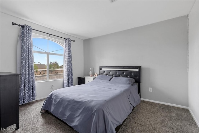 carpeted bedroom featuring baseboards