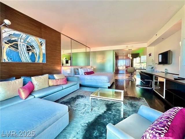 living area featuring wood finished floors and wooden walls