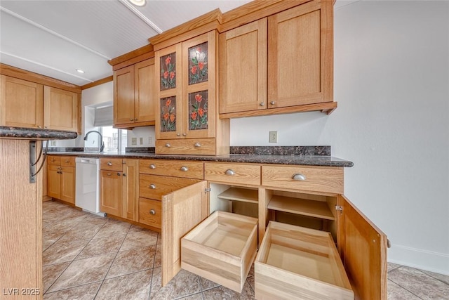 kitchen featuring dishwasher, dark stone countertops, light tile patterned flooring, and glass insert cabinets