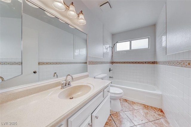 full bathroom with visible vents, toilet, tile walls, and  shower combination