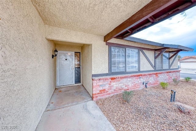 entrance to property with stucco siding