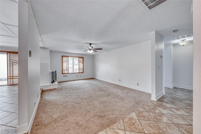 unfurnished living room with a ceiling fan, light tile patterned floors, light colored carpet, and visible vents