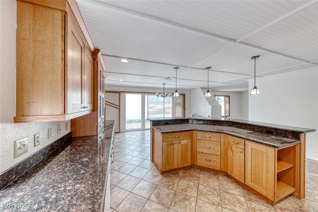 kitchen featuring hanging light fixtures, dark stone countertops, recessed lighting, and open shelves