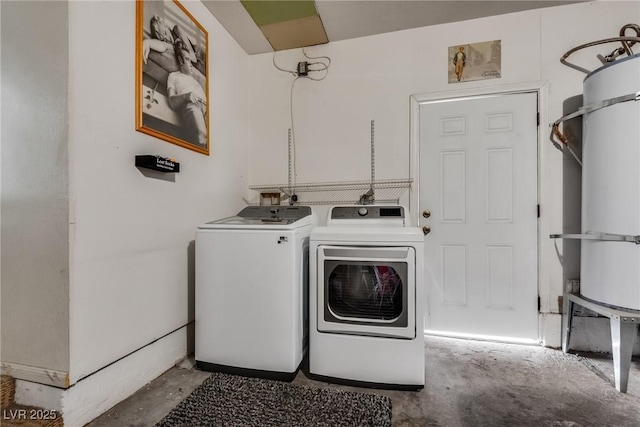 laundry room with water heater, laundry area, and washing machine and dryer