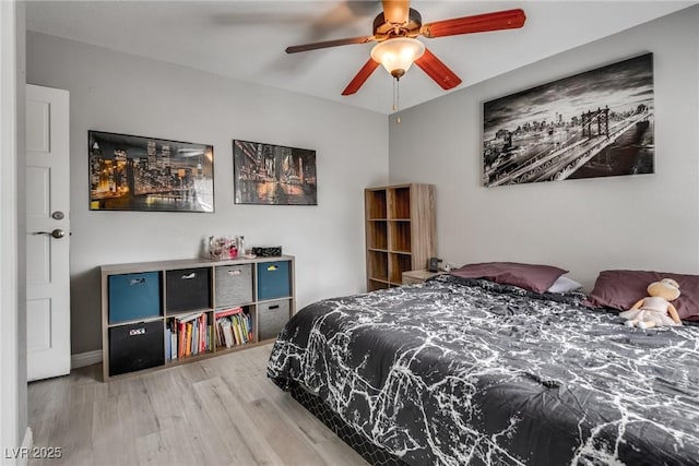 bedroom featuring a ceiling fan and wood finished floors