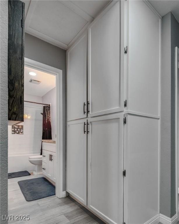 interior space with visible vents, baseboards, and light wood-style flooring