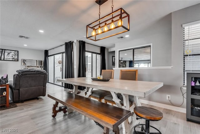 dining room featuring recessed lighting, baseboards, visible vents, and light wood-type flooring