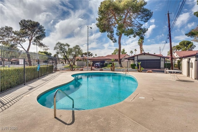 pool with a patio and fence