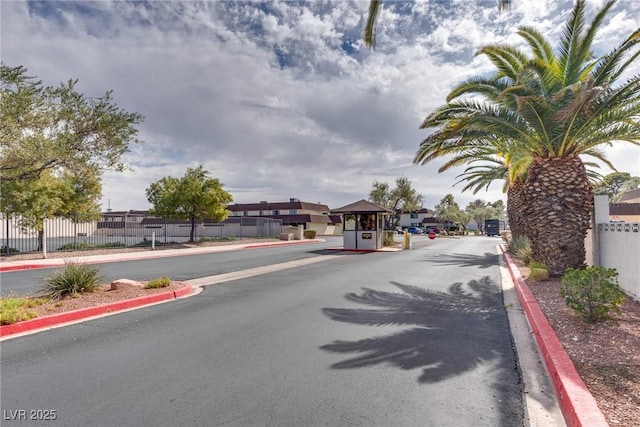 view of road featuring curbs and a gated entry