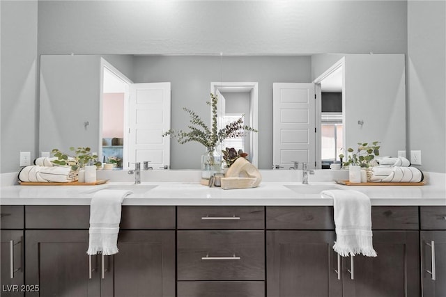 full bath featuring double vanity and a sink