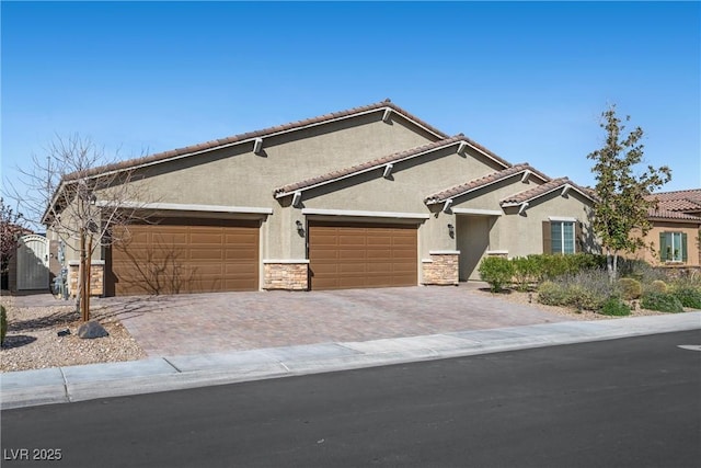 view of front of property with stone siding, stucco siding, decorative driveway, and an attached garage