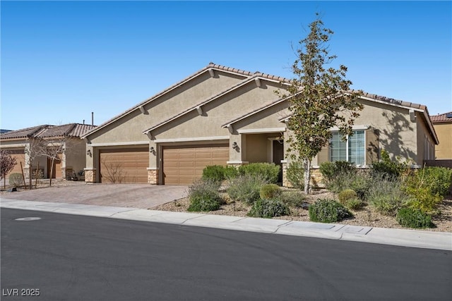 view of front of home featuring stucco siding, driveway, an attached garage, and a tile roof