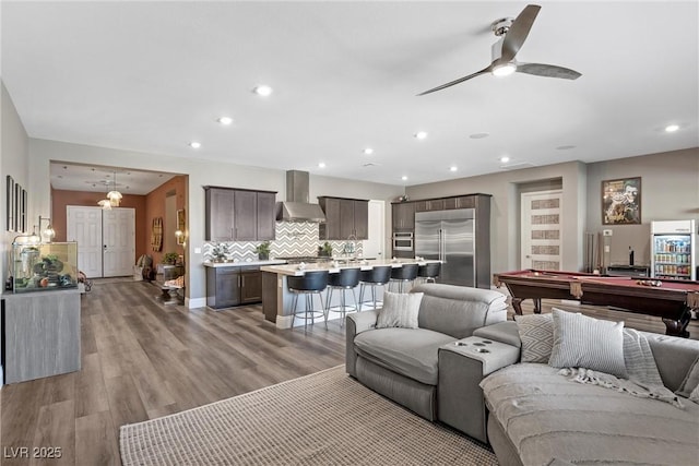 living room featuring light wood finished floors, pool table, baseboards, ceiling fan, and recessed lighting