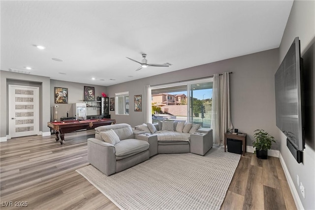 living room with baseboards, light wood-style flooring, and pool table