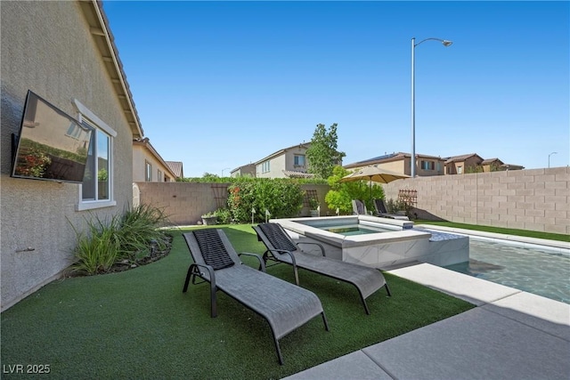 view of patio with an in ground hot tub and a fenced backyard