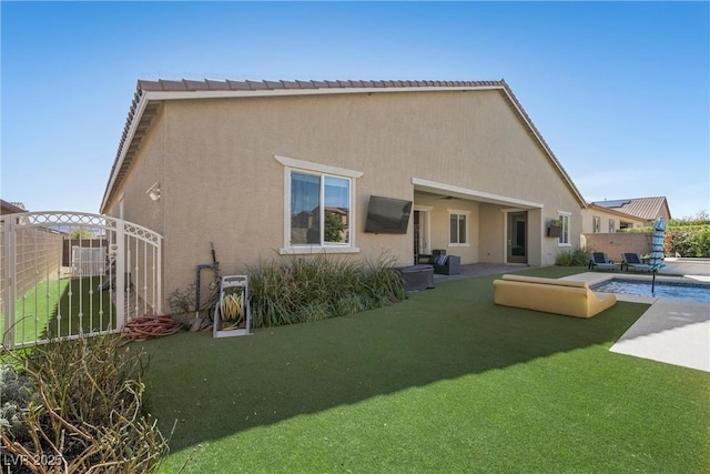 back of property with fence, a fenced in pool, stucco siding, a tiled roof, and a patio area