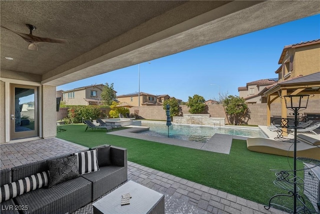 view of patio / terrace with an outdoor living space, a fenced backyard, a pool with connected hot tub, ceiling fan, and a residential view