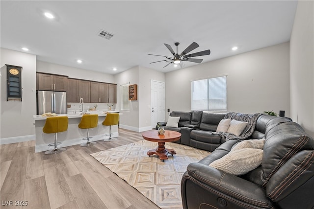 living room with recessed lighting, a ceiling fan, visible vents, and light wood-type flooring