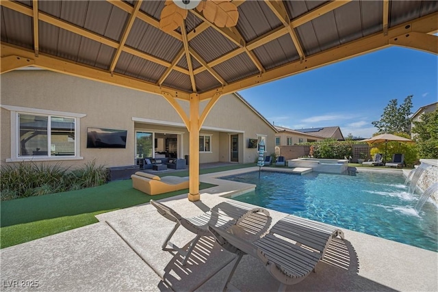 view of swimming pool with a patio area, a pool with connected hot tub, a gazebo, and fence