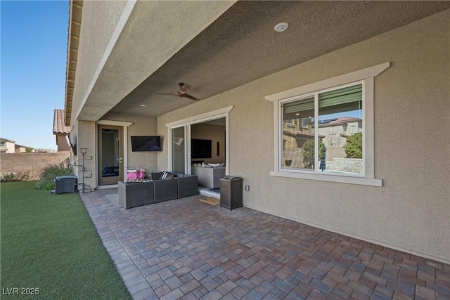 view of patio / terrace featuring an outdoor living space, ceiling fan, and fence