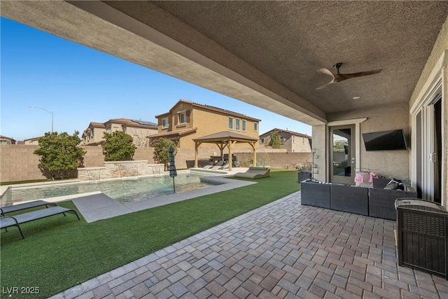 view of patio featuring a ceiling fan, an outdoor living space, a fenced backyard, a gazebo, and a fenced in pool