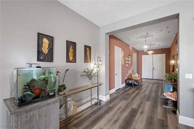 interior space with baseboards and wood finished floors