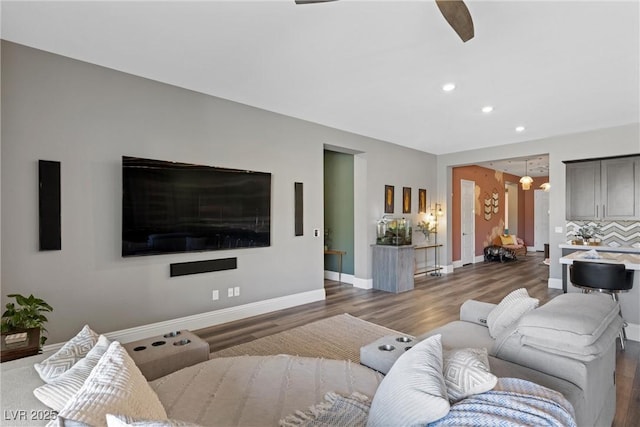 living room featuring recessed lighting, baseboards, and wood finished floors