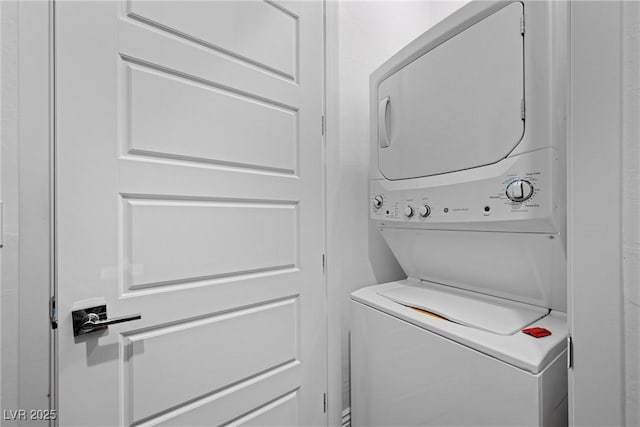 washroom featuring laundry area and stacked washing maching and dryer