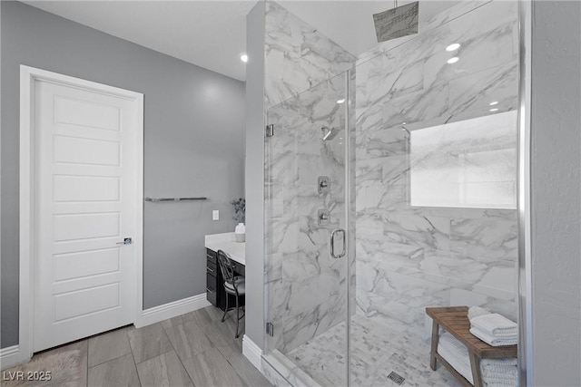 bathroom with vanity, baseboards, a marble finish shower, recessed lighting, and marble finish floor