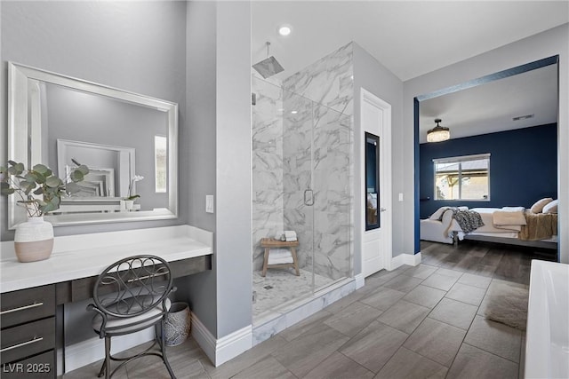 full bathroom with ensuite bath, baseboards, and a marble finish shower