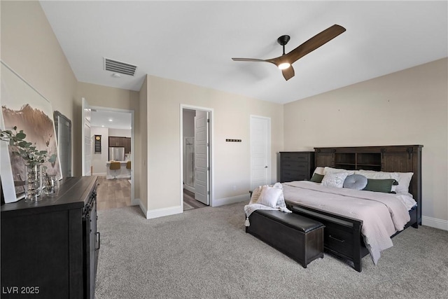 bedroom with light colored carpet, visible vents, ensuite bathroom, and baseboards