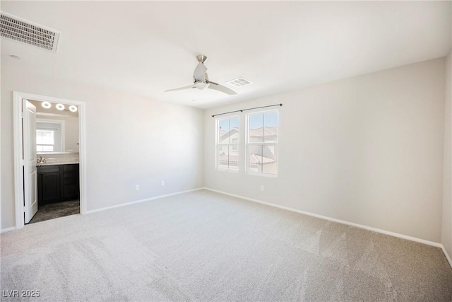 3158 Teaderman Walk, Henderson, NV 89044 - unfurnished bedroom featuring light carpet, baseboards, ensuite bath, and ceiling fan