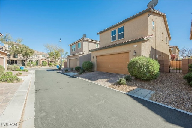 3158 Teaderman Walk, Henderson, NV 89044 - view of home's exterior with an attached garage, stucco siding, a gate, driveway, and a tile roof